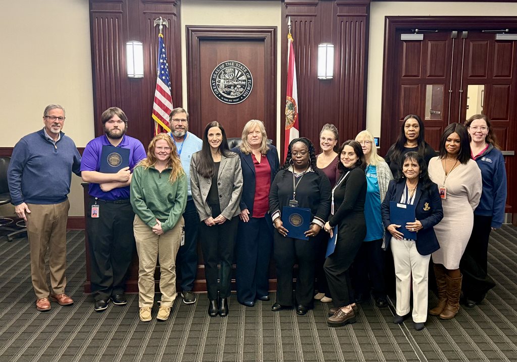 photo of Clerk employees standing in front of a judge's bench