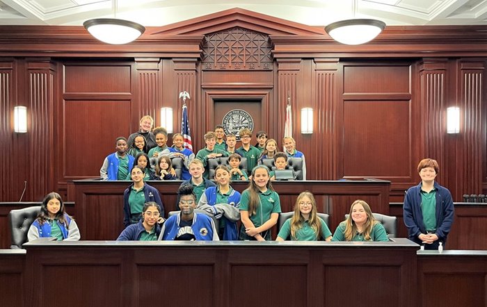 Students gathered around a judge's bench