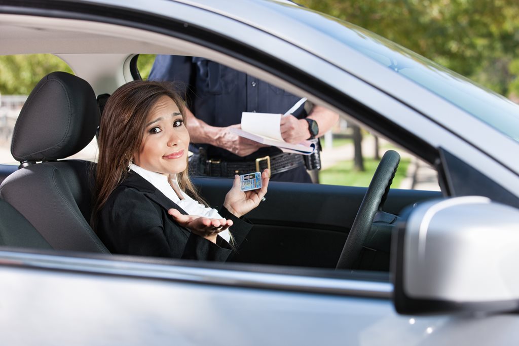 Woman receiving traffic citation in her car