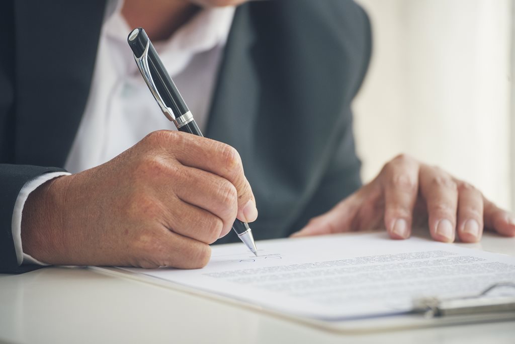 picture of a man signing a document